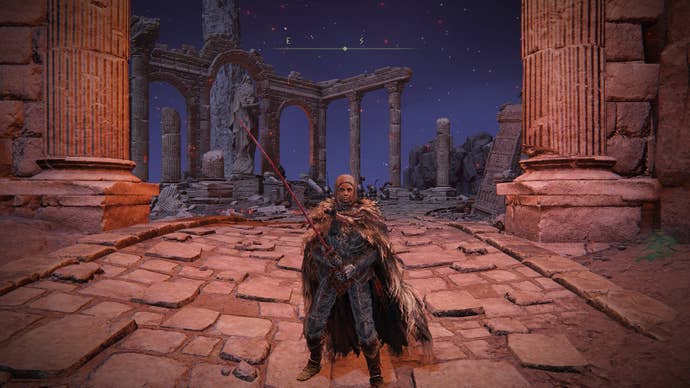 The player stands outside of Mohgwyn Dynasty Mausoleum wearing the White Mask in Elden Ring
