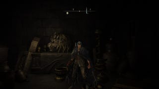 The Tarnished stands by a Divine Beast Head in the Belurat Tower Settlement Storeroom in Elden Ring Shadow of the Erdtree